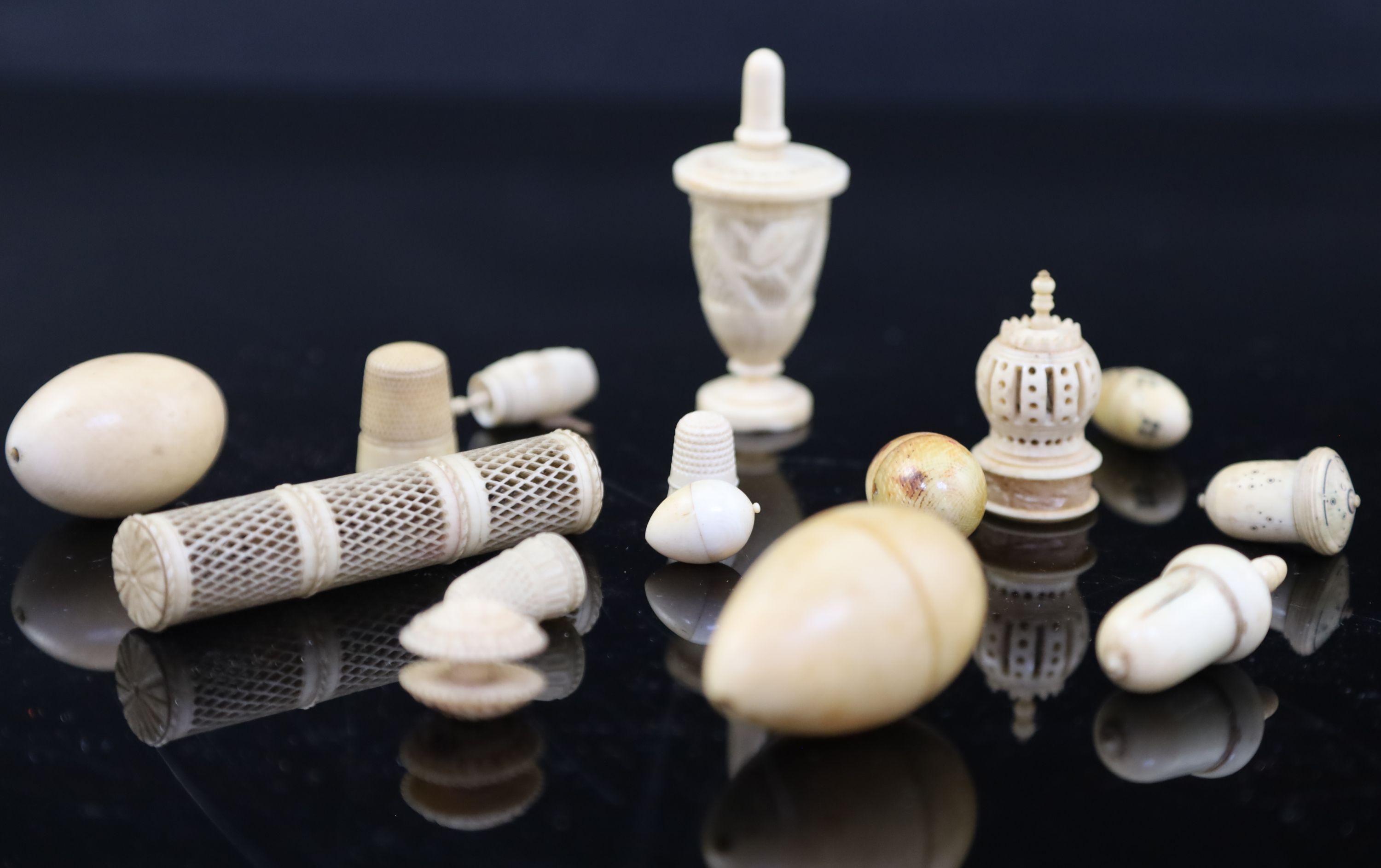 A collection of assorted early 19th century and later carved ivory sewing accessories